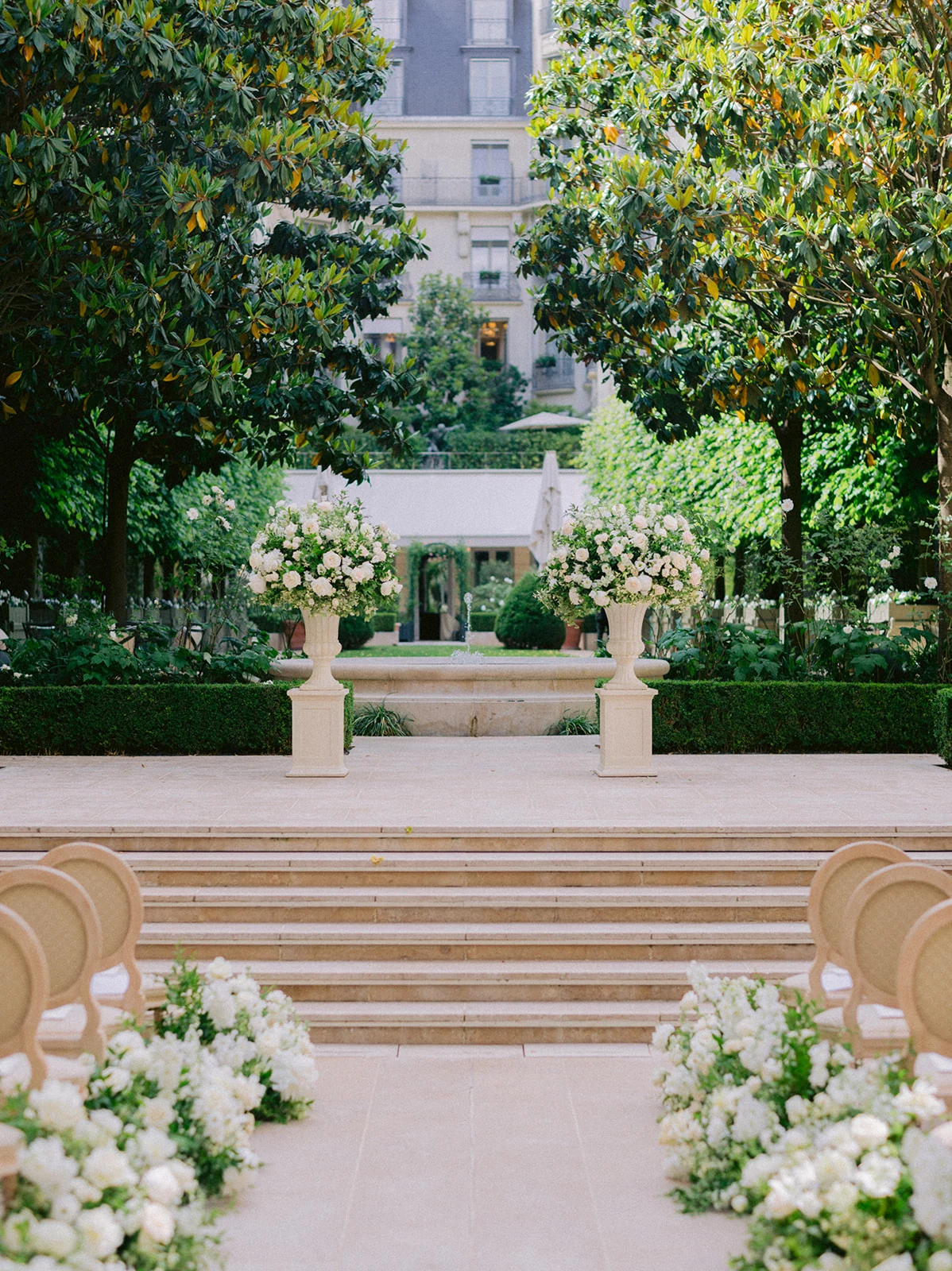 Symmetrical garden aisle prepared for a luxury wedding ceremony in Paris