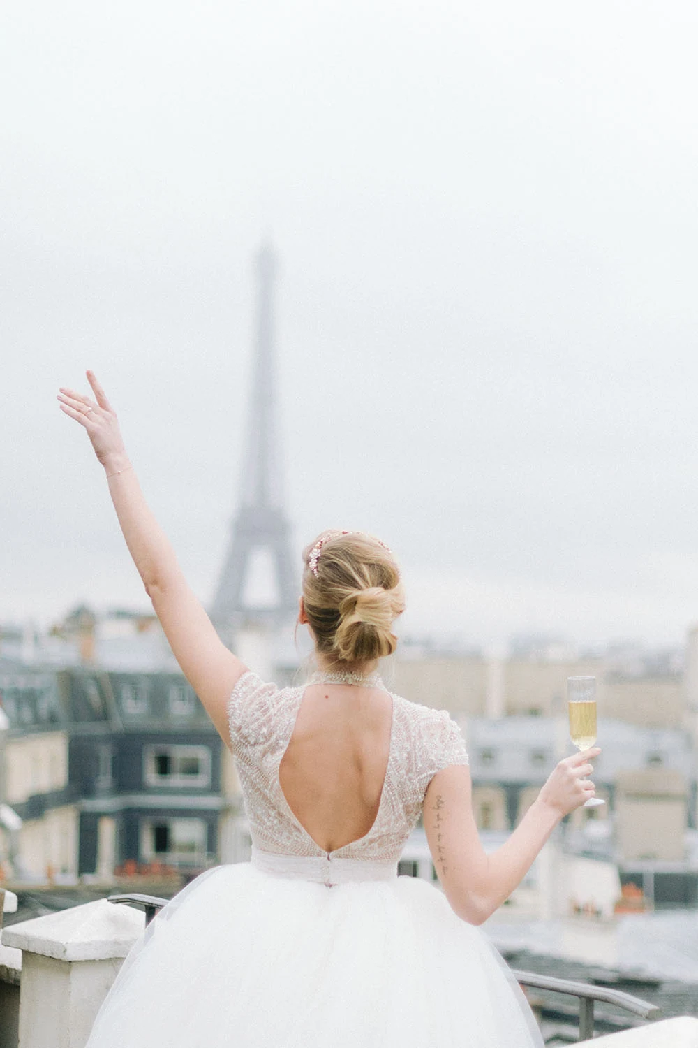 Bride drinking champagne on the Hôtel Marignan terrace