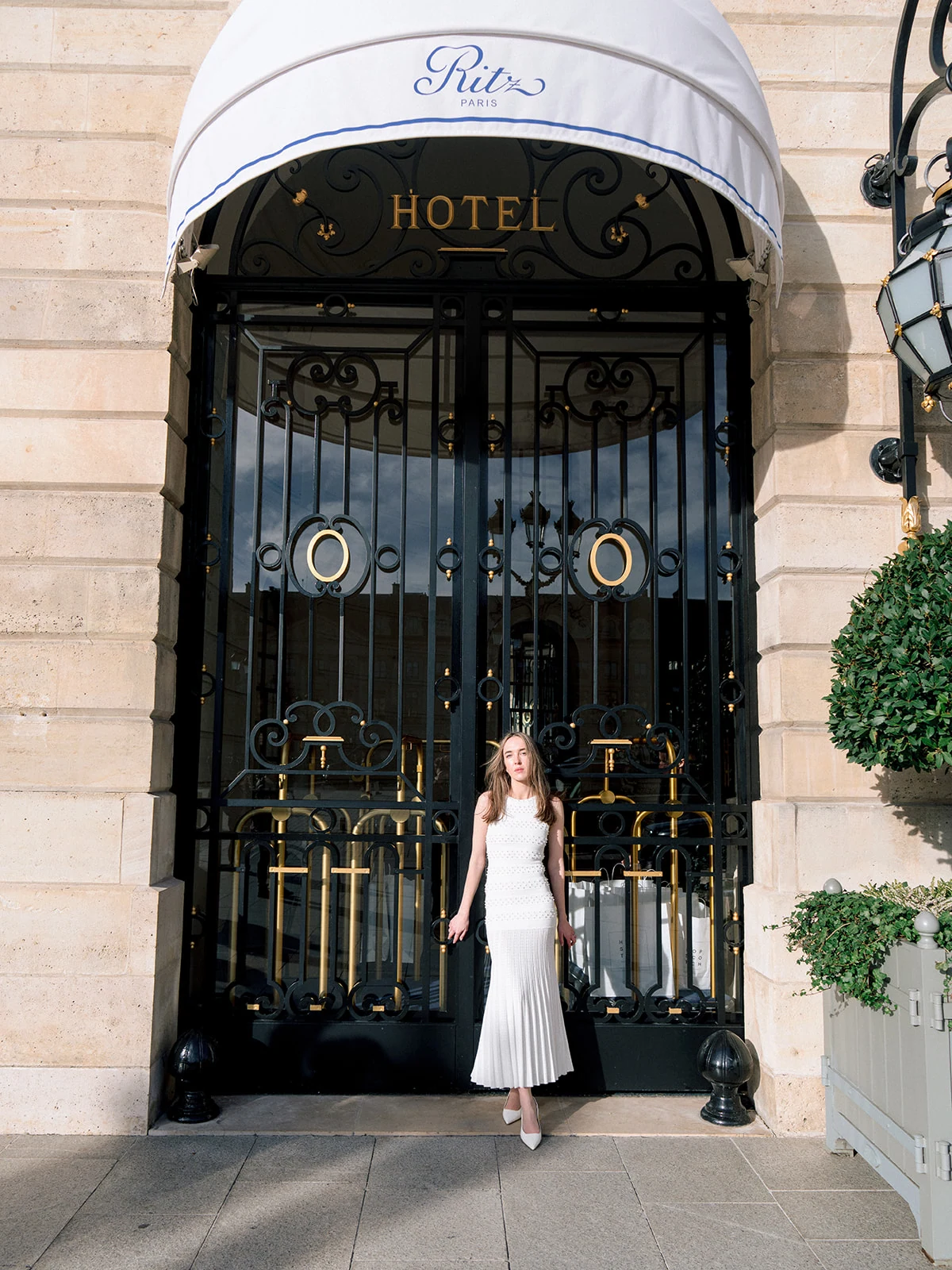 Editorial fashion portrait outside the entrance of the Ritz Paris on Place Vendôme