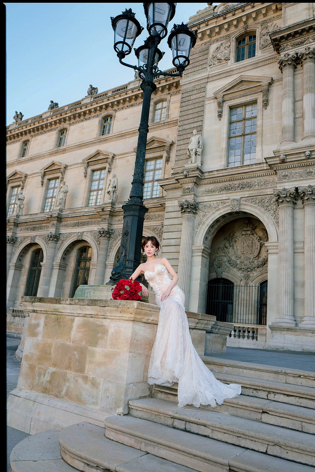 Romantic wedding portrait on the Louvre steps in Paris
