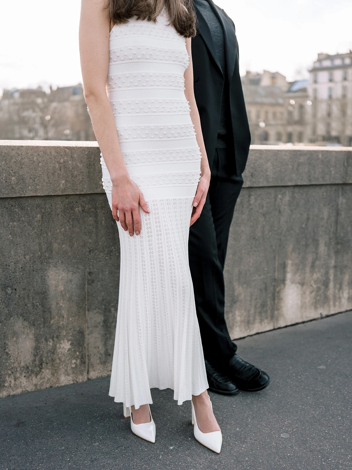 Fashion dress detail photographed in late daylight beside the Seine in Paris