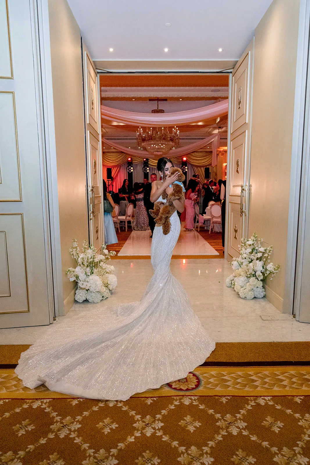 Bride with her dog framed by the reception entrance at Shangri-La Paris