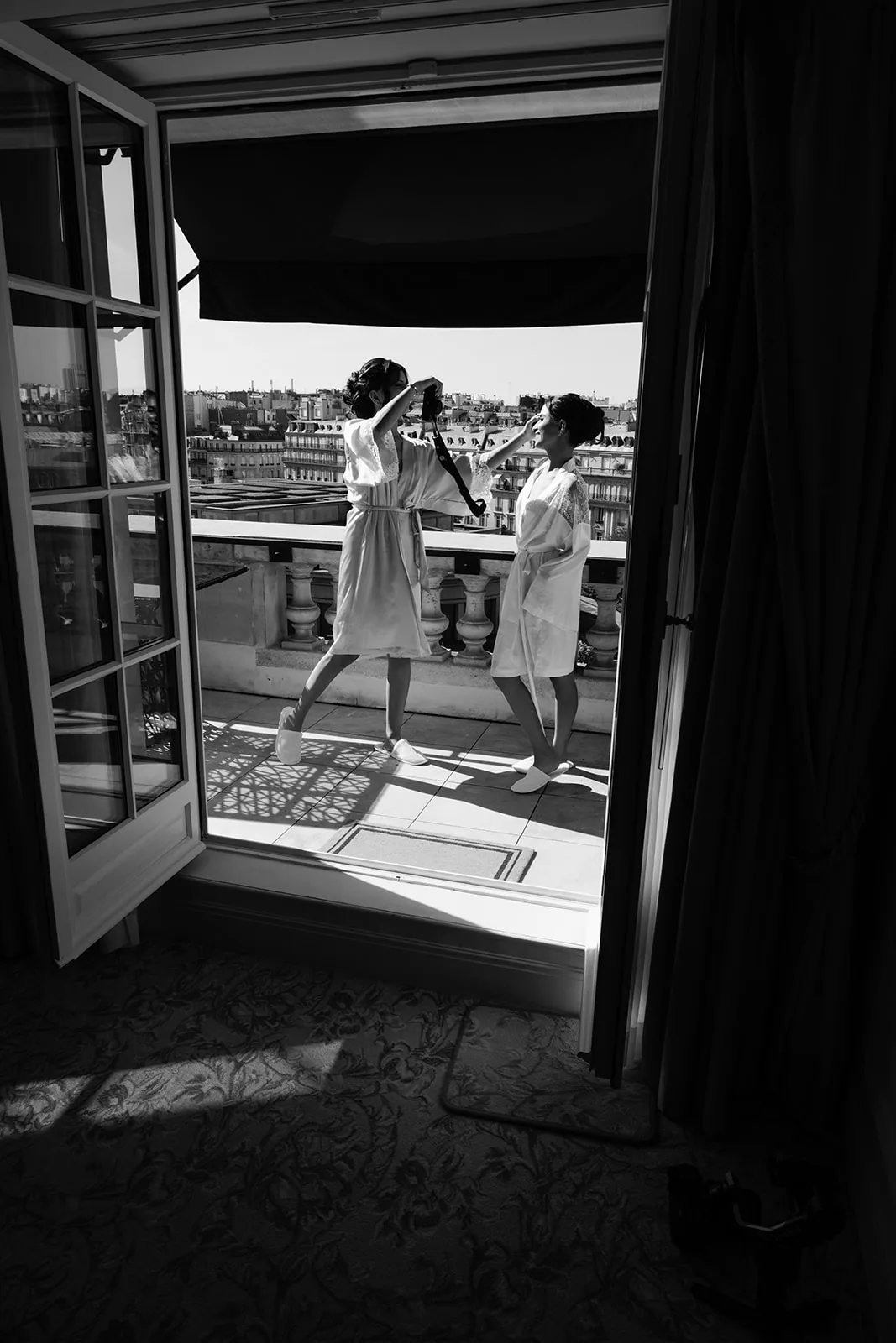 Bridal preparation in black and white on a balcony with a Paris view at Shangri-La Paris