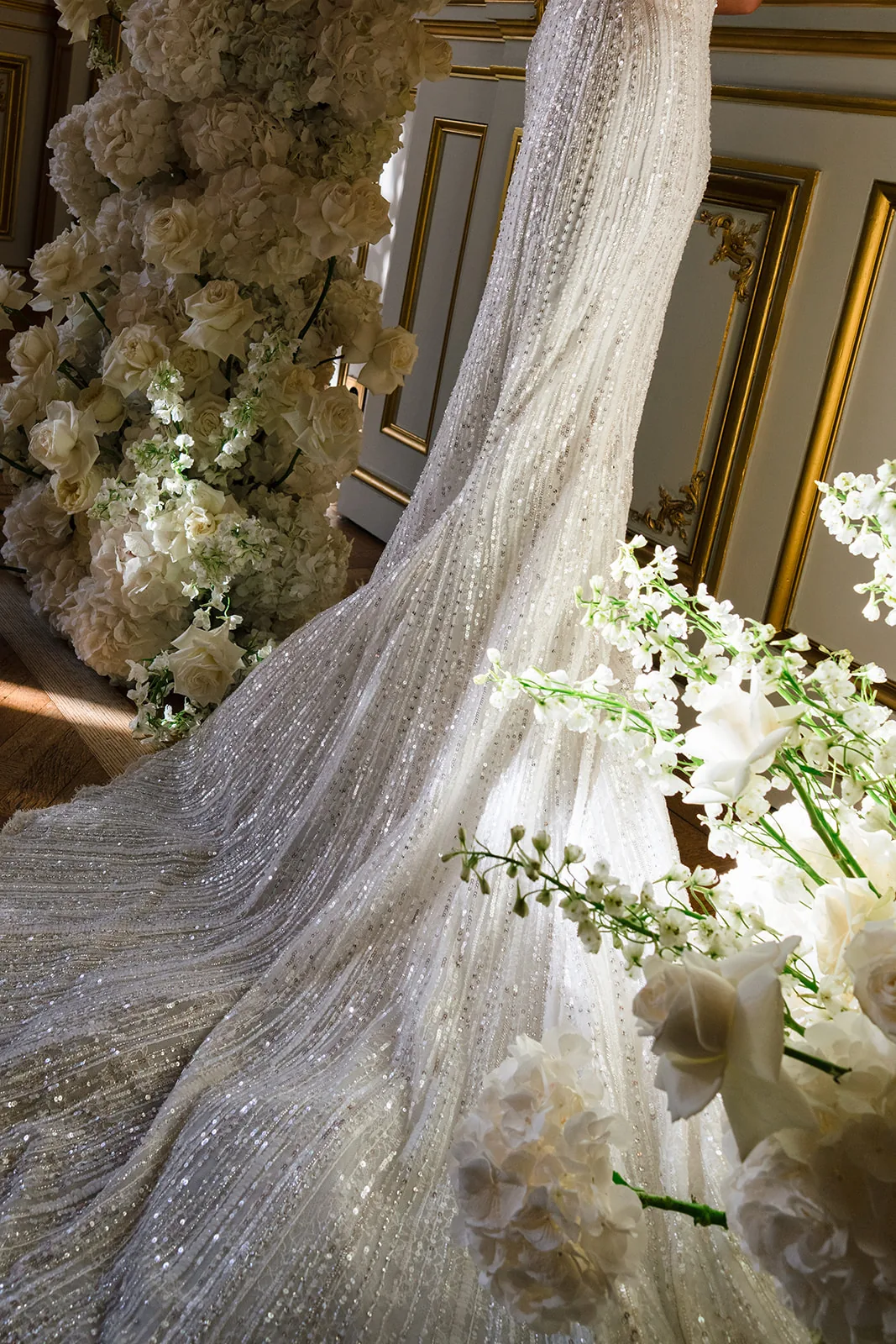 Sequinned wedding dress detail framed by white flowers at Shangri-La Paris