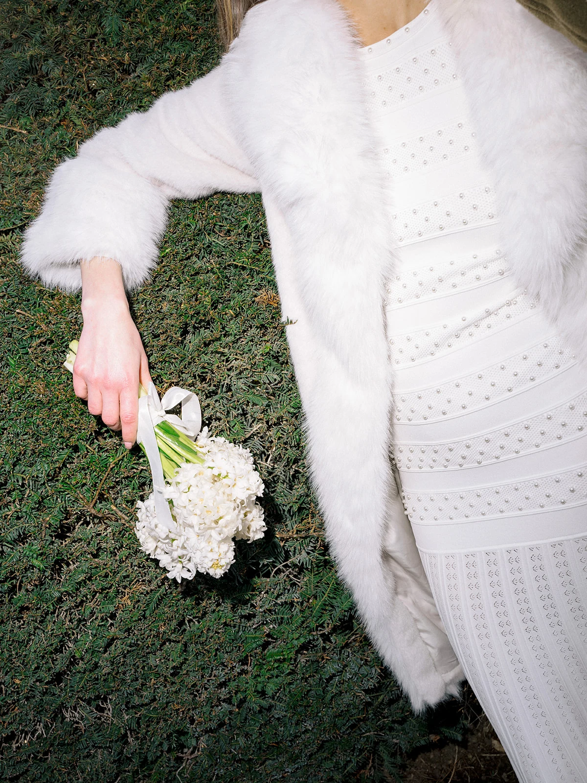 Editorial detail of white flowers and a fur coat in the Tuileries Garden