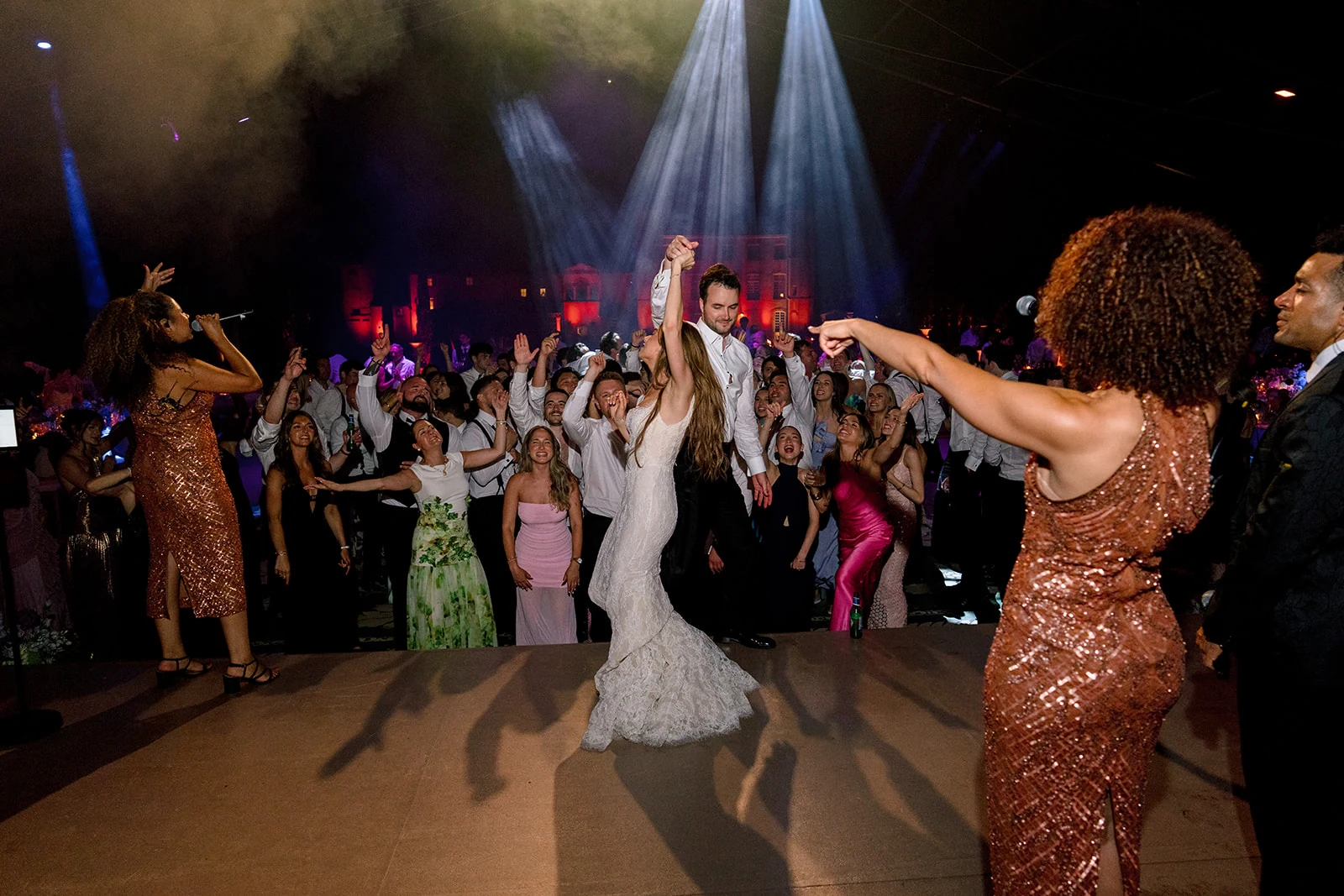 Bride dancing on stage with the live band and guests at Villa Baulieu