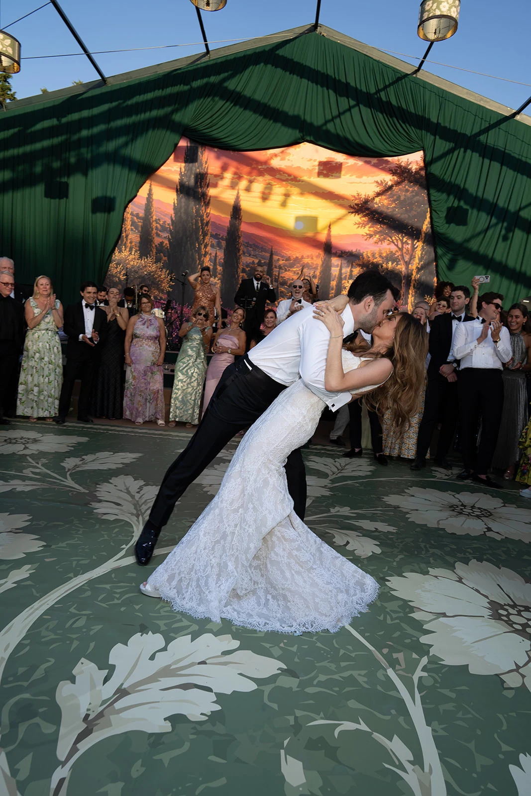 Bride and groom sharing a dramatic dip kiss during their first dance at Villa Baulieu