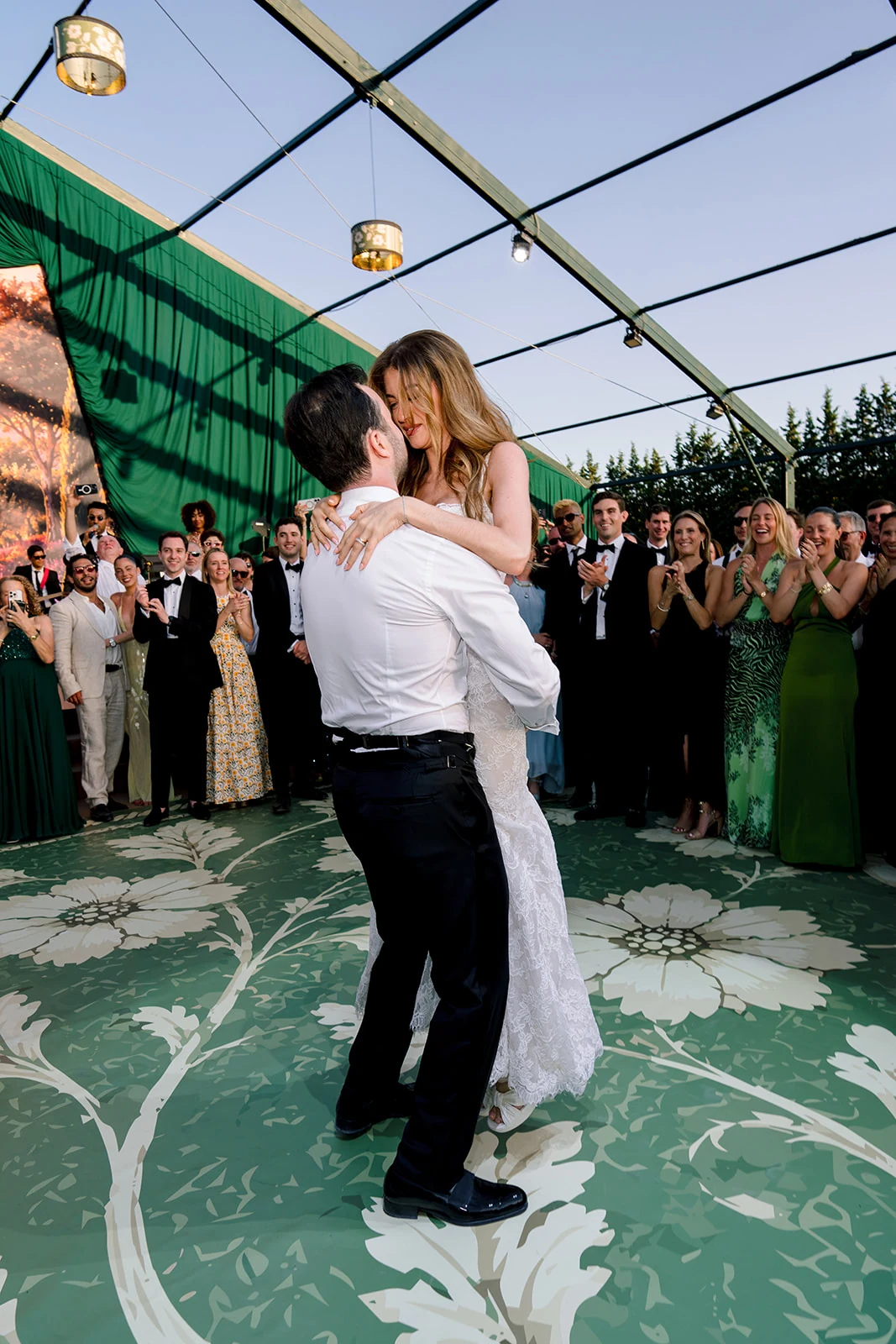 Groom lifting the bride during their first dance at Villa Baulieu