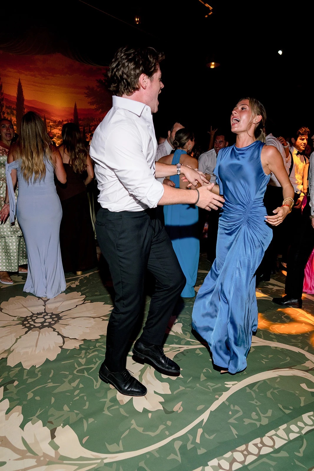 Wedding guests dancing together during the night party at Villa Baulieu