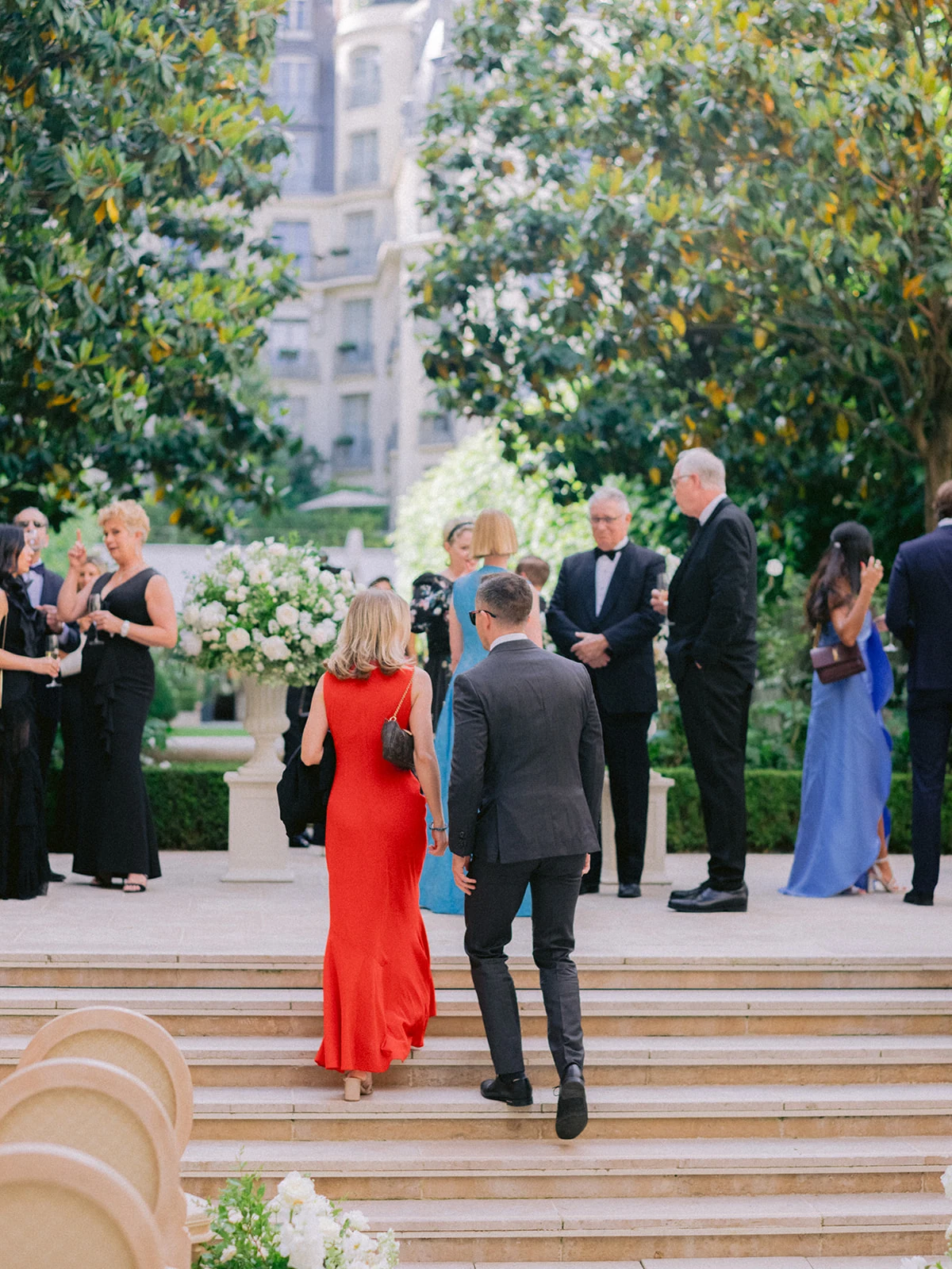 Wedding guests arriving for an outdoor garden ceremony in Paris