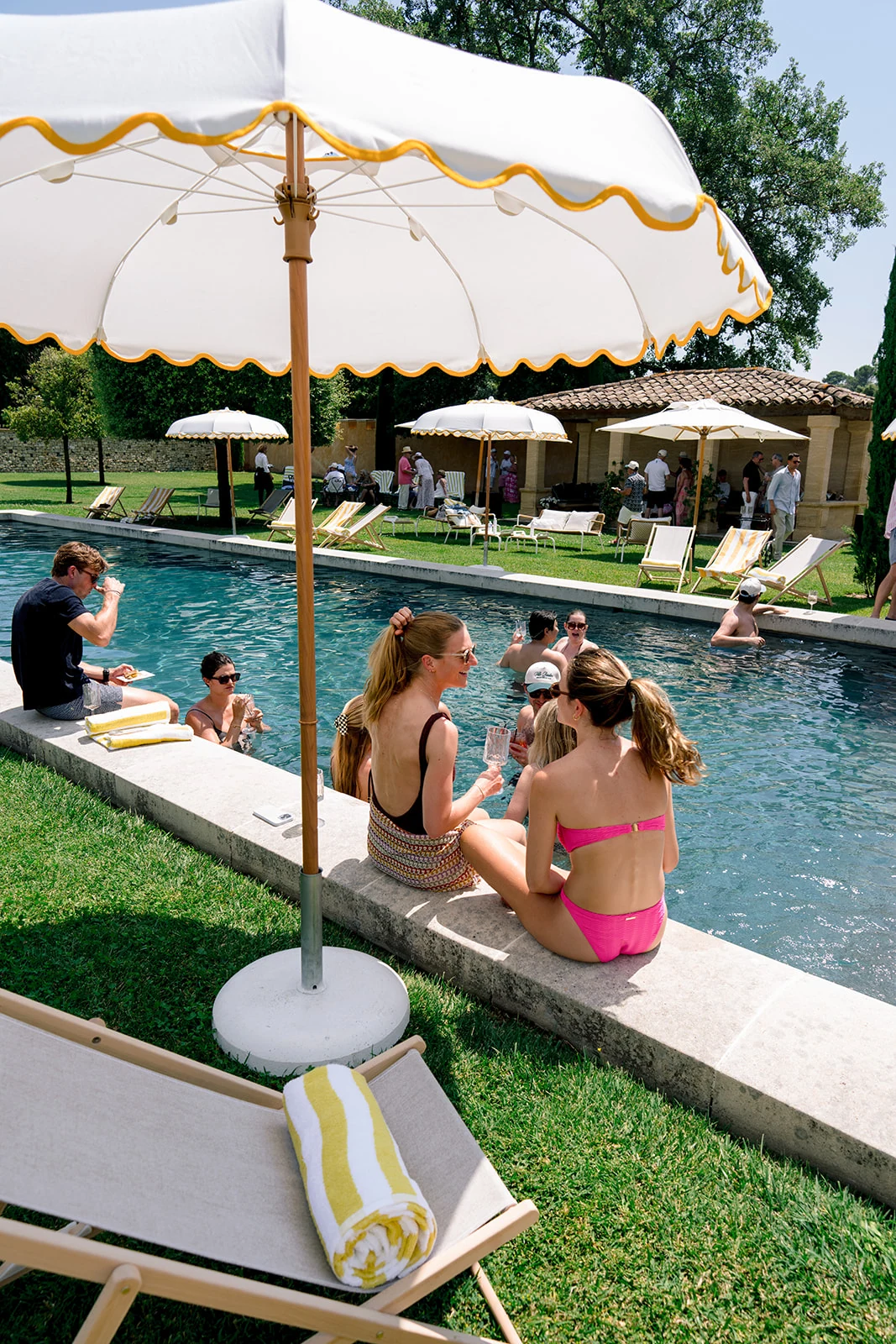 Wedding guests relaxing beside the pool during a destination wedding in Provence