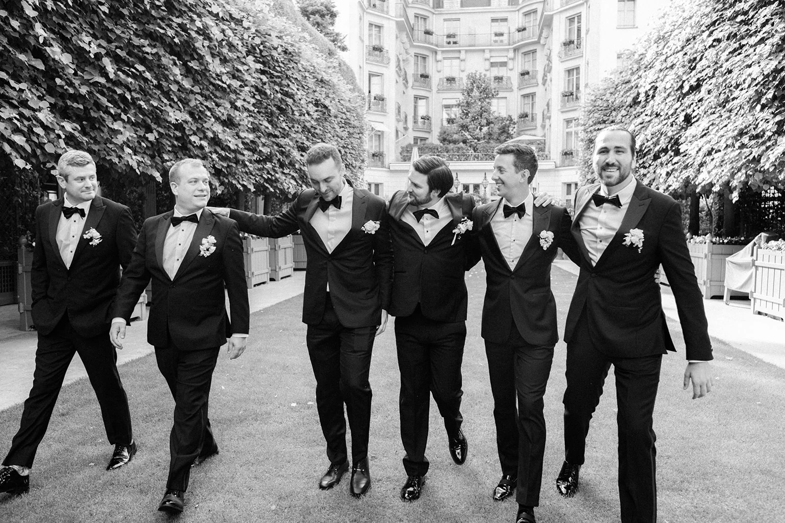 Editorial black-and-white portrait of groomsmen at a Paris wedding