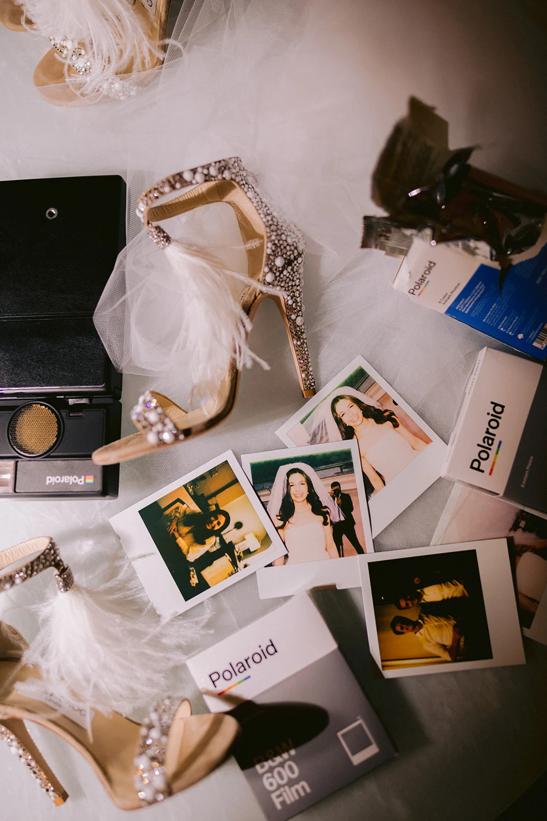 Embellished wedding shoes, veil and instant film arranged in a Peninsula Paris suite