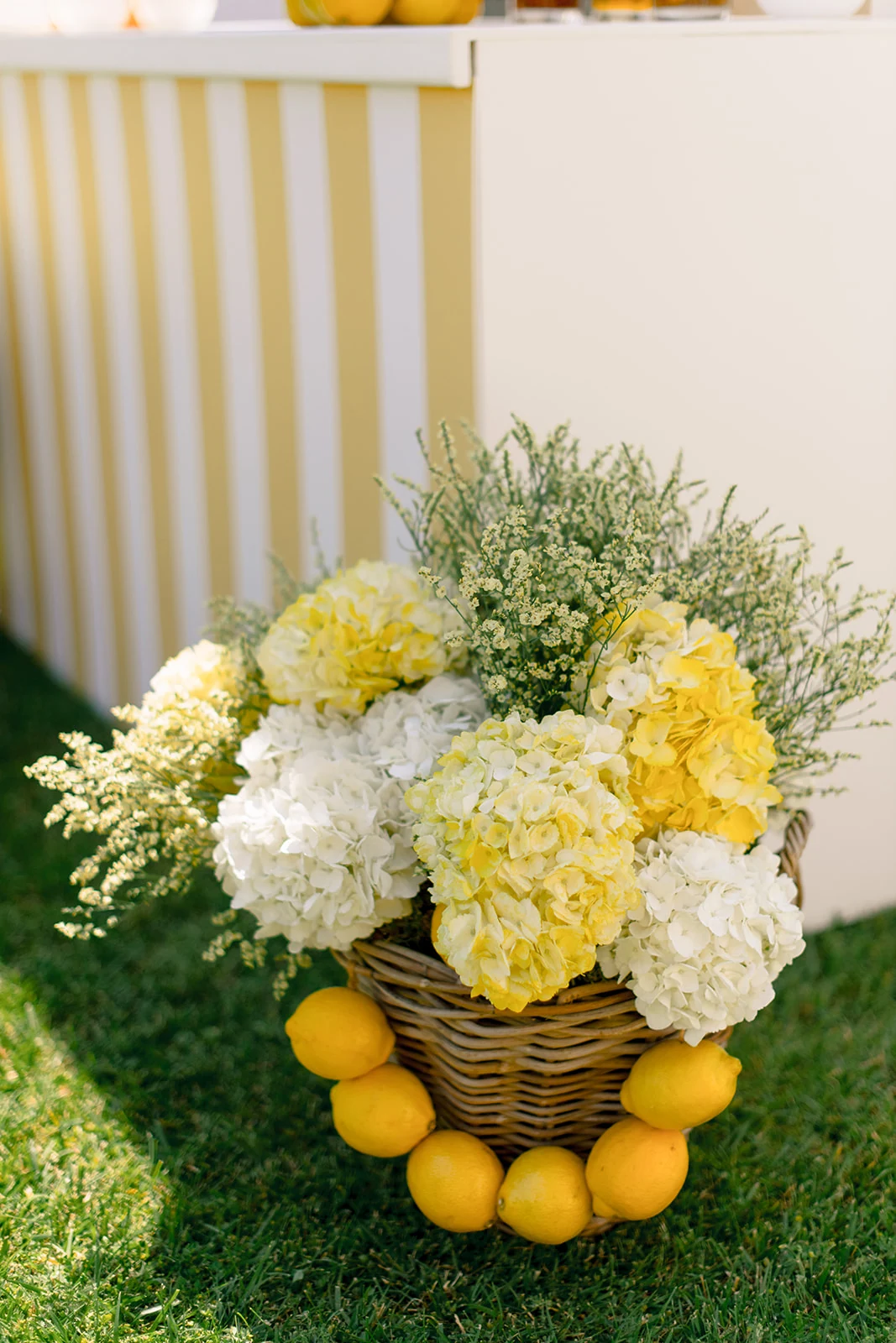 Yellow and white hydrangea floral decor with lemons for a wedding pool party