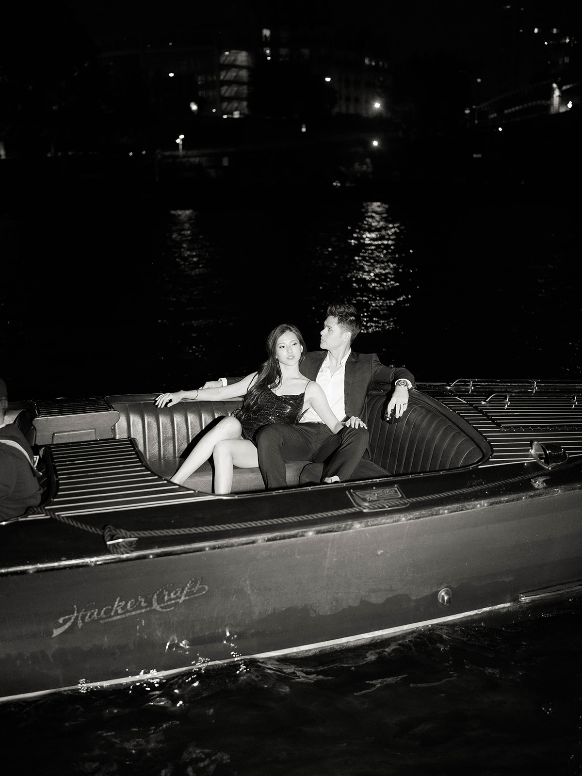 Couple sharing an evening moment aboard a boat on the Seine in Paris