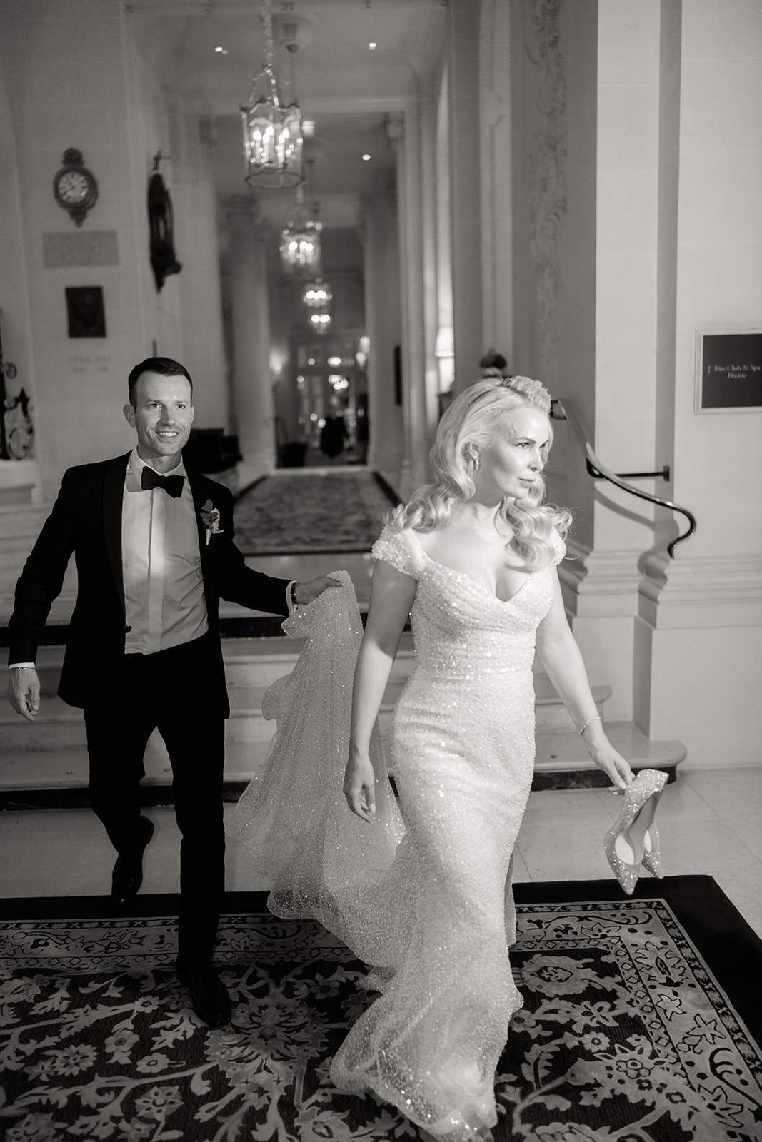 Bride and groom photographed at night outside The Ritz Paris