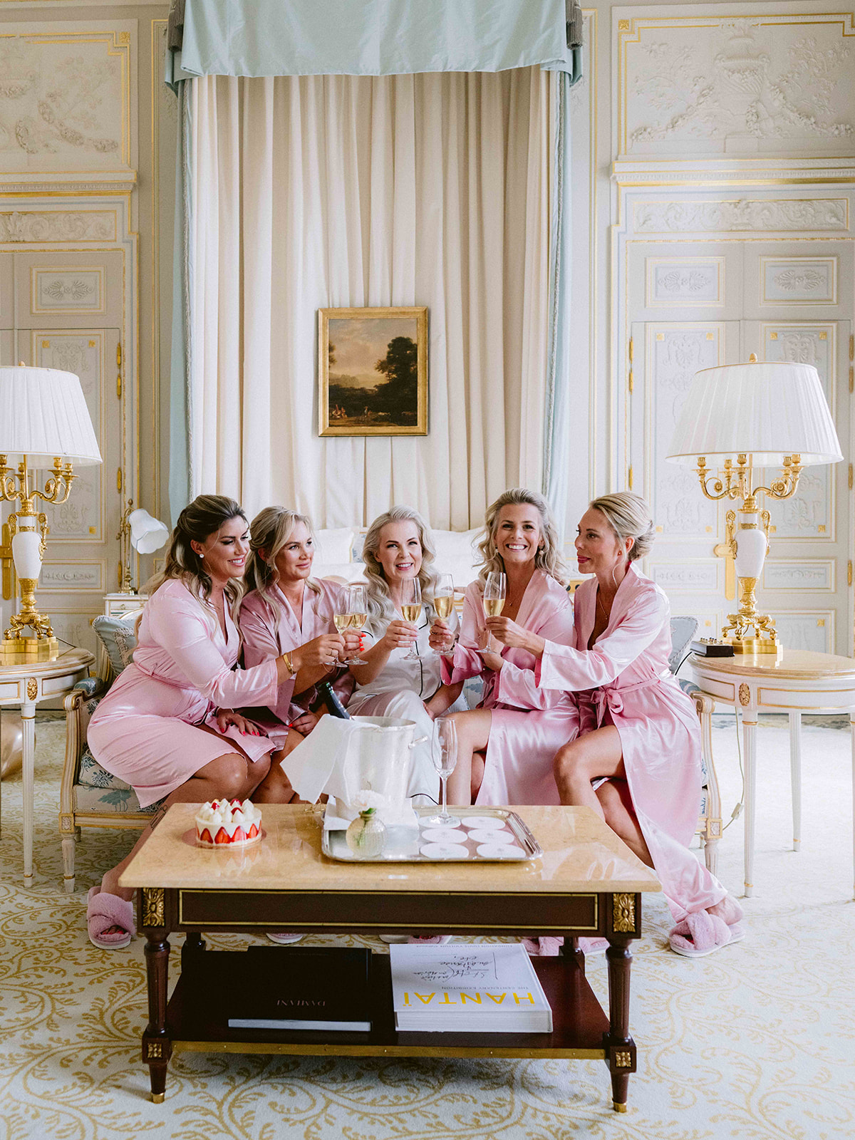 Bride and bridesmaids sharing a champagne toast inside The Ritz Paris